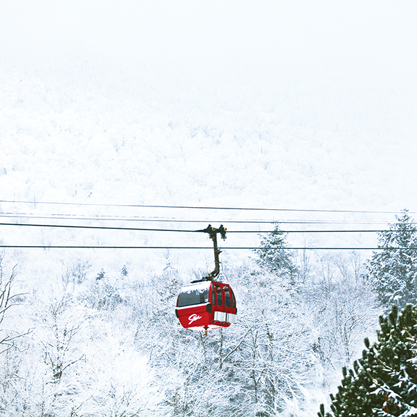 Red gondola in the snowy mountains
